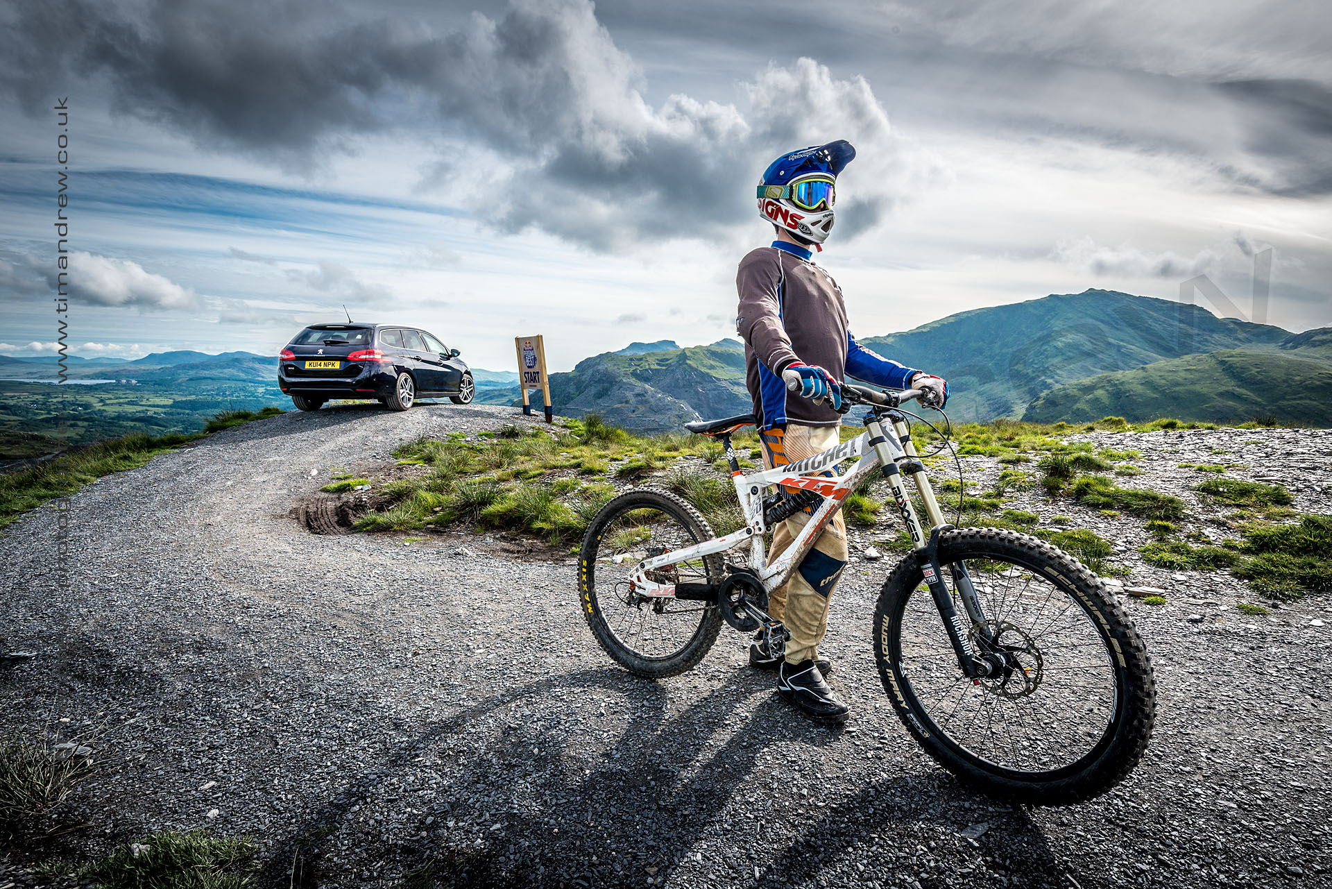 Downhill biker and Peugeot 308 at Antur Stiniog